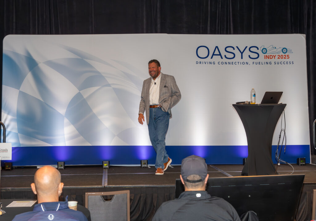 Man speaking in front of a group at a convention