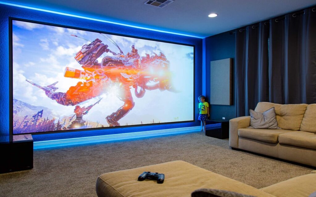 Living area with TV screen covering one wall